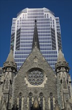 Old Christ Church Cathedral facade with rose window and modern architectural steel and blue tinted