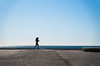 Jogger at the Olympic harbour in Barcelona, Spain, Europe