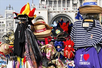 Colourful souvenir stall in Venice with hats, masks and striped shirts, Venice, Veneto, Italy,