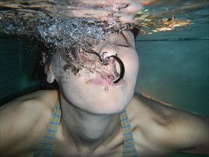 Woman Face with Eyes Closed Underwater with Bubbles in Switzerland. | MR:yes Maria-CH-20-04-2022
