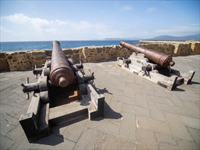 Old cannons, fortress wall of Alghero, Sardinia, Italy, Europe
