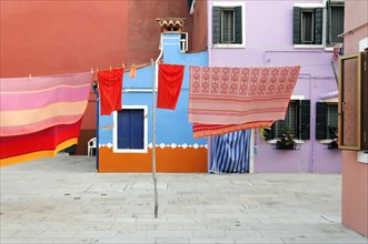 Colourful houses, Burano, Burano Island, Laundry hanging in front of pastel-coloured houses on an