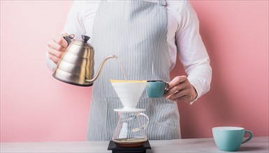 Barista using pour-over technique to brew coffee, exhibiting precision with pastel colors
