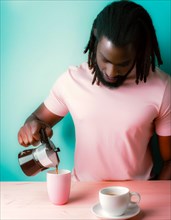 A black man with afro hairstyle focused on pouring coffee into a pink cup against a serene blue