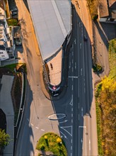 Bird's eye view of overpass and intersecting roads, with traffic and long shadows, Calw, Black