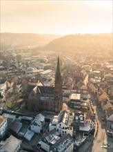 Evening sun bathes the town in golden light, church towers rise up, sunrise, Nagold, Black Forest,