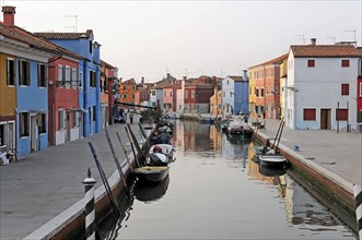 Colourful houses, Burano, Burano Island, The tranquil scene of a canal with reflections of boats