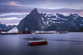 Landscape on the Lofoten Islands. The village of Hamnoy. A small boat in the foreground, blurred by