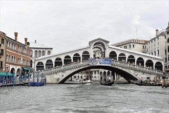 Famous Rialto Bridge over the Grand Canal in Venice on a cloudy day, Venice, Veneto, Italy, Europe