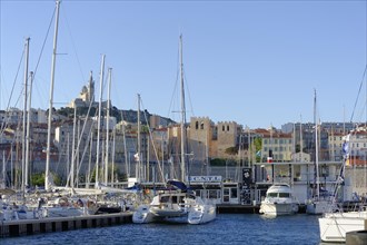 Sailing boats and yachts moored in the harbour with a view of the city of Marseille, Marseille,