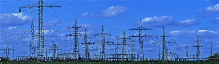 Power pylons with high-voltage lines at the Avacon substation Helmstedt, panoramic photo,