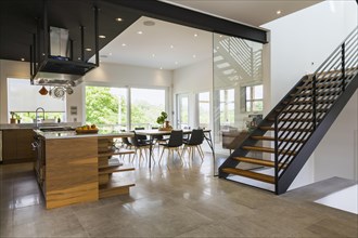 Kitchen, dining room and American walnut wood and black powder coated cold rolled steel stairs