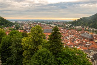 View over an old town with churches in the evening at sunset. This town lies in a river valley of