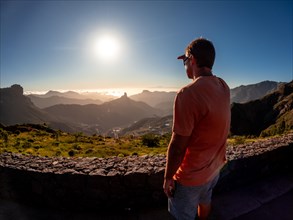 A young boy at sunset near Roque Nublo in Gran Canaria, Canary Islands
