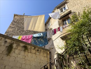 Historic courtyard with a washing line against a blue sky