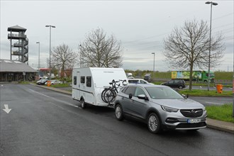 Car with caravan parked on a motorway service area, Tank und Rast, Wetterau Ost service area,