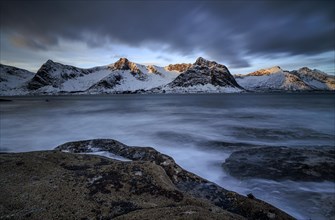 Rocky coast off Bergen, sea, waves, spray, morning mood with clouds, long exposure, winter,