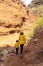 Family visiting the limestone canyon Barranco de las Vacas in Gran Canaria, Canary Islands