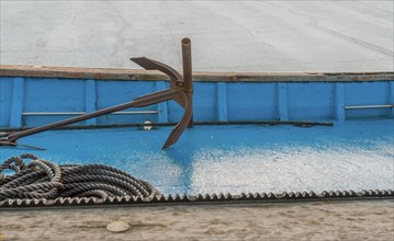 Anchor and rope laying on deck of dry docked fishing boat in South Korea