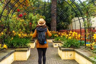 A woman walking through a beautiful botanical garden, a sustainable tourism concept in Arucas, Gran