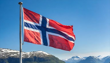 The flag of Norway flutters in the wind, isolated against a blue sky