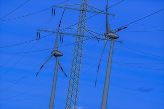 Wind energy in an inclined position, theme photo, electricity pylon with high-voltage lines and