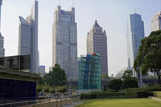 Skyscrapers of Pudong Special Economic Zone, Urban scene with skyscrapers next to green areas under