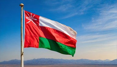 The flag of Oman flutters in the wind, isolated against a blue sky