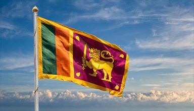 The Sri Lankan flag flutters in the wind, isolated against a blue sky
