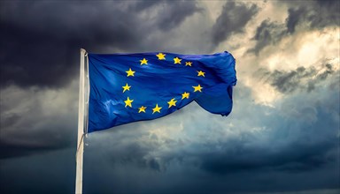 The flag of the EU flutters in the wind, isolated, against dark gloomy clouds