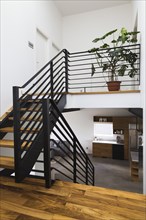 American walnut wood and black powder coated cold rolled steel stairs inside modern cube style