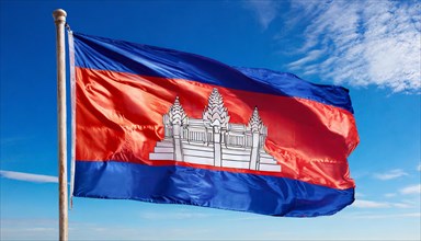 The flag of Cambodia, fluttering in the wind, isolated, against the blue sky