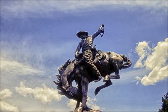 Cowboy on bucking horse, monument, Teton County, Jackson, Wyoming, USA, North America