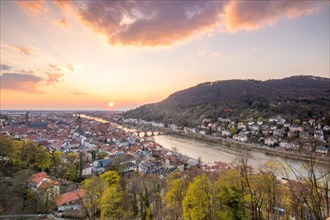 View over an old town with churches in the evening at sunset. This town lies in a river valley of