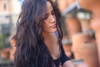 Close-up of a pensive woman with long brunette hair