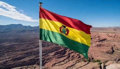 The flag of Bolivia flutters in the wind, isolated against a blue sky