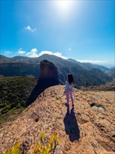 A woman tourist at the Roque Palmes viewpoint near Roque Nublo in Gran Canaria, Canary Islands