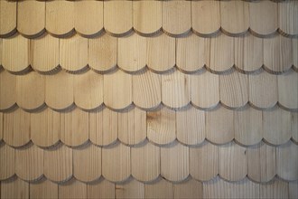 Wooden shingles are arranged like fish scales, surface, pattern and background