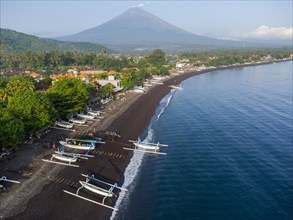 Fishermen coming back from fishing in the morning, in the background Mount Agung, Amed, Karangasem,