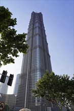 Jin Mao Tower, nicknamed The Syringe at 420 metres, a skyscraper with an impressive facade rises