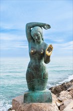 Bust of a siren or mermaid with worn hands and breasts in Sitges, Spain, Europe