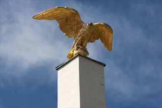 Gilded eagle on an obelisk at the main entrance to Schoenbrunn Palace, Vienna, Austria, Europe