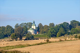 Rural landscape view with fields and a country church in Sweden, Sloeta, Falkoeping, Sweden, Europe