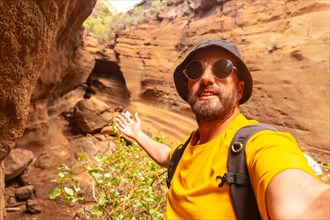 Selfie of a man enjoying in the limestone canyon Barranco de las Vacas in Gran Canaria, Canary
