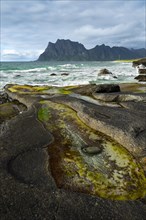 Seascape on the beach at Uttakleiv (Utakleiv), with rocks and water-filled rocky outcrops in the