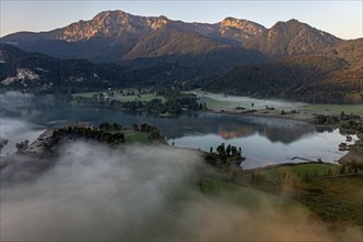 Aerial view of a mountain lake, mountains reflected in the lake, morning light, fog, summer, Lake
