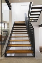 American walnut wood and black powder coated cold rolled steel stairs inside modern cube style