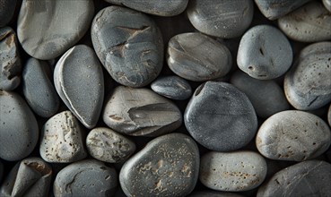 Top view of smooth river pebbles in shades of gray and tan AI generated