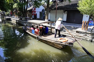 Excursion to Zhujiajiao Water Village, Shanghai, China, Asia, Boatman navigates a tourist boat on