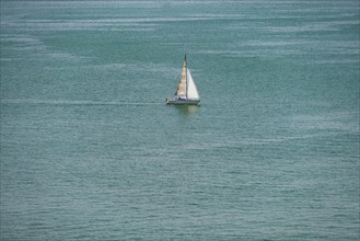Sailing boat on the turquoise waters of Lake Constance, near Meersburg, Baden-Wuerttemberg,